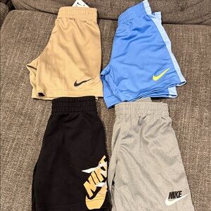 4 pairs of Nike Kids Shorts- Tan, Blue, Black, Gray